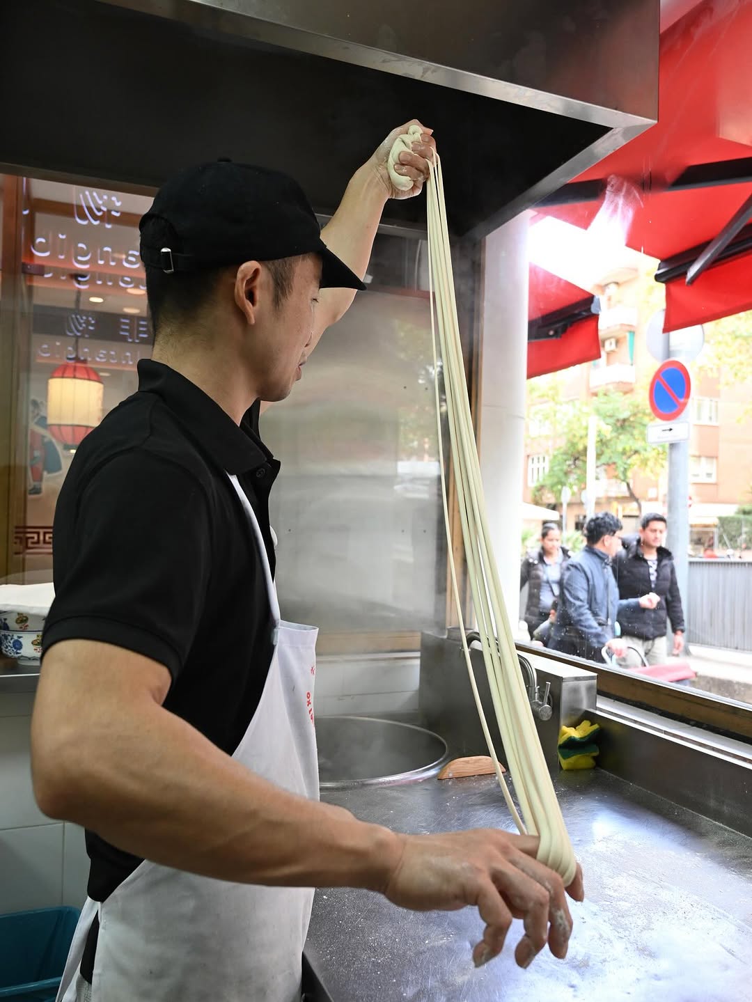 Maestro fideuero tirando fideos a mano en Sant Andreu